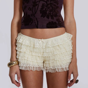 Women Mesh Lace Bloomer Shorts in cream with layered ruffles and bow detail, offering stylish comfort and lightweight design for lounging or layering.